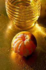 Golden scale. The concept of thirst and hunger. Fresh Mandarin and a touch of water