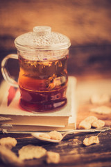 green circle in the scarf, the window with maple leaves and drops after rain in autumn / season when you need warm drinks