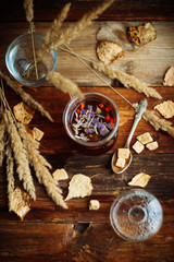 Teapot and cup with flower tea and on a black wooden table