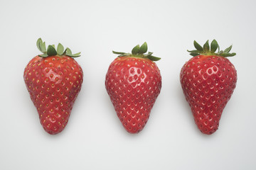 three strawberry on white background