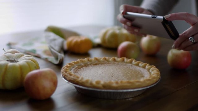 Closeup Of Woman Taking Photo Of Pumpkin Pie On Smartphone, At Home, Slow Motion, 4K
