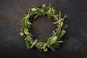 Christmas wreath of rosemary on a beautiful brown background © alexeysulima11