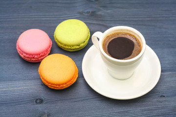 coffee and macaroons on a blue wood background