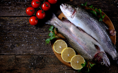 Organic raw fresh trout fish on an old wooden background. Top view. 
