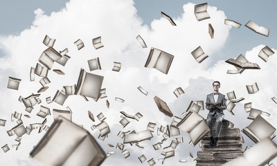 Young businessman or student studying the science and books fly 