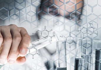 Portrait of concentrated male scientist working with reagents in laboratory