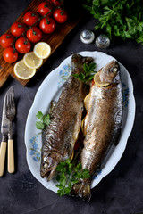 Baked trout with parsley, green onions, tomato, lemon and thyme.