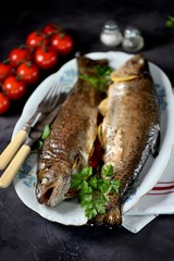 Baked trout with parsley, green onions, tomato, lemon and thyme.