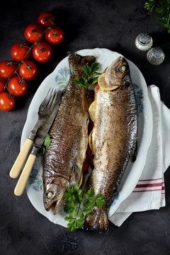 Baked trout with parsley, green onions, tomato, lemon and thyme.