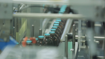 Pharmaceutical industry. Production line machine conveyor at factory with bottles. pharmaceutical production of liquid pharmaceuticals