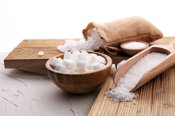 differnt kind of sugar in wooden bowl and spoon.
