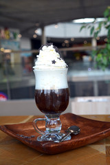 Viennese coffee with whipped cream on glass cup.