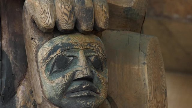 totem pole face with hand on top closeup 4k