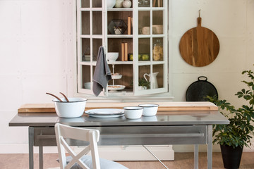 kitchen cupboard with metal table and plates