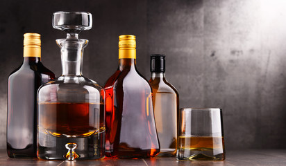 Obraz na płótnie Canvas Carafe and bottles of assorted alcoholic beverages.