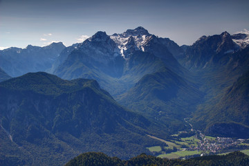 Snowy Triglav peak from north with forested Jerebikovec peak, deep glacial Vrata, Kot and Sava valleys and Mojstrana village in a sunny autumn day, Triglav National Park, Julian Alps, Slovenia, Europe © nogreenabove2k