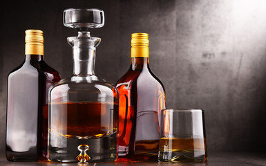 Carafe and bottles of assorted alcoholic beverages.