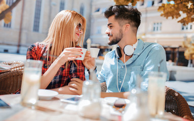 Romantic couple drinking coffee and lemonade, having a date in the cafe. Dating, love, relationships