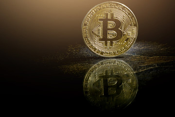 Golden bitcoin on black background with copy space cryptocurrency mining concept