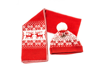 The christmas scarf and the bonnet on the white background. The objects are isolated on white and a...