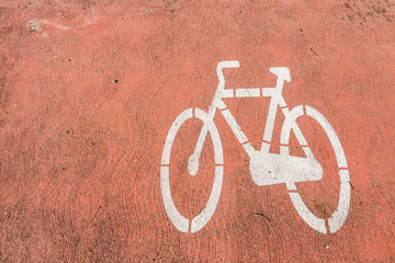 Cycling sign marking on red concrete asphalt