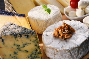 Different sorts of cheese on kitchen table