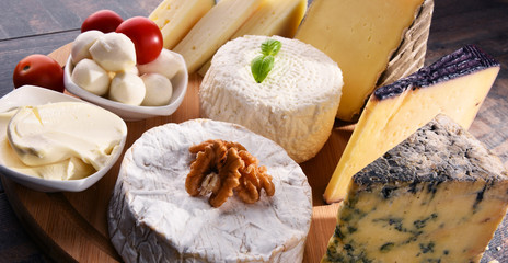 Different sorts of cheese on kitchen table
