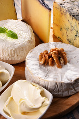 Fototapeta na wymiar Different sorts of cheese on kitchen table