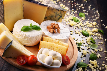 Different sorts of cheese on kitchen table