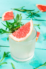 Alcohol drink, Rosemary, Grapefruit & Gin Cocktail, On light blue wooden table background, copy space