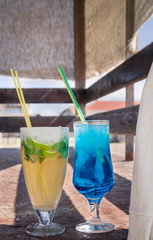 Colourful cocktails with ice on the beach in the hot summer