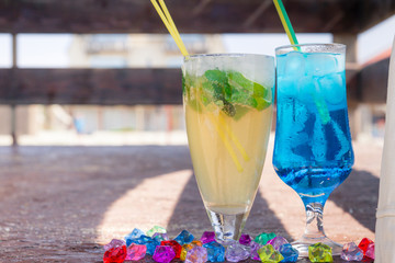 Colourful cocktails with ice on the beach in the hot summer