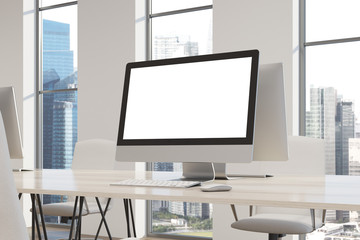 White computer screen on a white desk