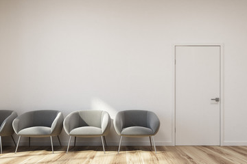 White waiting room, gray chairs