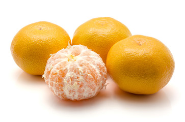 Four tangerines isolated on white background one peeled.
