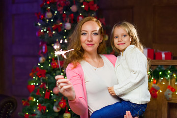 Mom and daughter having fun at a New Year's celebration, holding