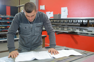 engineer in mechanical factory reading instructions
