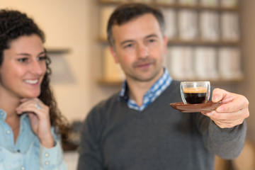 inspecting a cup of coffee