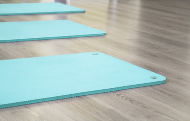 Yoga mat on wooden floor
