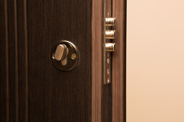 Obraz premium Contemporary metal door with a lock closeup