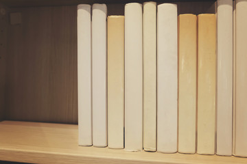 Book stacks in the room.shallow depth of field.low light and grain effect