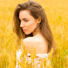 Brunette woman on wheat field