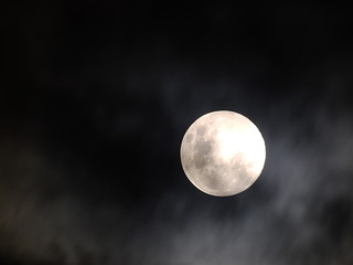 mysterious moon shrouded in a lot of mist generating a climate of doubt, uncertainty, insecurity and danger