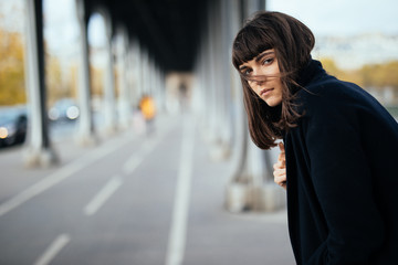 Fototapeta premium Fashion portrait trendy woman in Paris street at autumn under bridge
