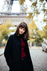 Fototapeta premium Outdoor fashion portrait of glamour sensual young stylish lady wearing trendy fall outfit , black coat on Cold season on Paris streets