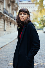 Fototapeta premium Closeup portrait of effective girl smiling to camera on Paris street on with Eiffel background.