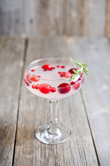 Tasty christmas cocktail with cranberry and foxberry. Shallow depth of field. Selective focus.