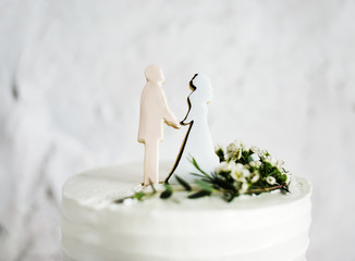 Closeup of groom and bride wedding cake topper