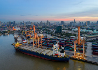 Naklejka premium Containers yard in port congestion with ship vessels are loading and discharging operations of the transhipments in international port.