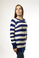 woman in a striped sweater on a white background